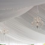 Experience a luxurious ambiance in Atlanta with T3 Event Rentals. Our elegant draped fabric ceilings, complete with stunning crystal chandeliers and tiny interwoven string lights, are perfect for creating a sophisticated atmosphere. Everything you need to transform your event is available for rent through T3 Event Rentals.