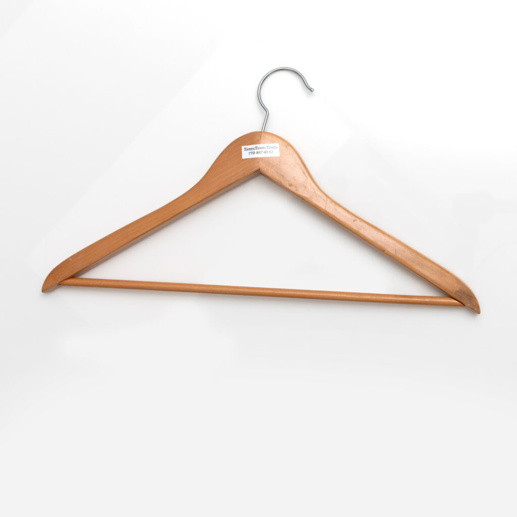 A wooden Hanger For Coat Rack featuring a metal hook is prominently displayed against a white background. A label on the top proudly reveals its origin from an upscale rental collection in Dahlonega.