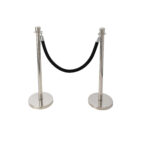 1. In Atlanta, T3 Event Rentals offers two silver stanchions connected by a black velvet rope, perfect for crowd control or defining spaces at your event. 2. Enhance the organization of your next North Georgia gathering with T3 Event Rentals elegant silver stanchions and black velvet ropes. 3. For events in Forsyth County, choose T3 Event Rentals to provide sophisticated crowd management solutions with our rental of sleek silver stanchions and plush black velvet ropes. 4. Elevate your Dawsonville event with T3 Event Rentals stylish rentals—two silver stanchions linked by a luxurious black velvet rope, ideal for managing crowds or setting boundaries. 5. In Dahlonega, rely on T3 Event Rentals for the finest crowd control options using our elegant silver stanchions paired with a rich black velvet rope to outline spaces beautifully.