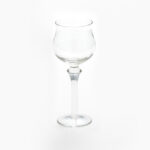 The Optic White Wine Glass (25 rack) from T3 Event Rentals features a short stem and wide bowl, elegantly set against a plain white background. Perfect for events in Atlanta, this rental item adds a touch of class to any gathering.