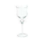 The Optic White Wine Glass (25 rack) elegantly stands against the white backdrop, featuring a slender stem and slightly flared rim that highlights its pristine design. Perfect for any event in Forsyth County, this exquisite glassware is available for rent exclusively through T3 Event Rentals.