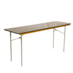 Under a simple white backdrop, the Rectangle Folding Tables from T3 Event Rentals are shown standing upright with a wooden top and white metal legs, perfect for versatile use in Atlanta. All items available for rental only.
