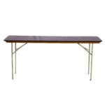 The Rectangle Folding Table from T3 Event Rentals, perfect for events in Dawsonville, showcases a long, rectangular dark wooden top paired with sleek light-colored metal legs. This stunning piece creates a striking contrast against a plain white background. Remember, its available only as a rental through T3 Event Rentals!.