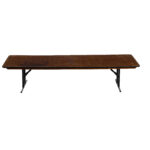 The Rectangle Folding Table boasts a sleek, elongated wooden design with a rich dark finish, complemented by sturdy black metal folding legs. Perfect for any event in Atlanta, its elegant versatility shines when placed against a pristine white background from a direct angle. Remember, all items are rentals and available to elevate your gathering through T3 Event Rentals.