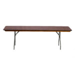 Looking for versatile and stylish rental options in Dawsonville? Our Rectangle Folding Tables at T3 Event Rentals feature a dark brown wooden surface and slightly angled metal legs for extra support. These tables stand out elegantly against a white background, perfect for adding function and style to your event setting. Rent from T3 Event Rentals for your next Dawsonville gathering!.