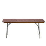 The Rectangle Folding Table, available for rent through T3 Event Rentals, showcases a rustic wooden top with sturdy metal legs. Its worn, stained surface adds unique character against a white background when unfolded. Perfect for events in Atlanta, this table brings charm and functionality to any occasion.