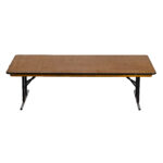 Discover the charm of a long rectangular wooden table with sturdy metal legs that effortlessly fold for versatile use. Its worn surface adds unique character against a plain white backdrop—ideal for your events in Atlanta. Experience this perfect example of Rectangle Folding Tables, available exclusively through T3 Event Rentals. Whether youre planning a wedding or corporate gathering, trust T3 Event Rentals to provide high-quality table rentals in Atlanta.