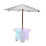 Transform your Dawsonville event with a stunning setup from T3 Event Rentals. Picture a white patio umbrella shading the Lit 30 Round Cocktail Table, whose hollow base emits a serene multicolored glow with shades of blue, pink, and green. This unique combination adds an elegant and luminous touch to any special occasion. Rent from T3 Event Rentals for all your party needs in Dawsonville!.