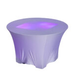 Experience the enchanting ambiance of The Lit 30 Round Cocktail Table from T3 Event Rentals, dressed in a fitted white tablecloth and casting a gently glowing purple light at your next event in Forsyth County. Transform your venue with this stunning rental piece available through T3 Event Rentals.