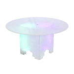 Elevate your event in Atlanta with the Lit 30 Round Cocktail Table from T3 Event Rentals. This rental features a stunning frosted glass top and a mesmerizing color-changing glowing base, casting vibrant hues of turquoise and purple. Its modern geometric design adds a sleek, contemporary flair to any occasion as it reflects dynamic light. Let T3 Event Rentals illuminate your Atlanta gathering with style!.