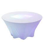 Transform your Atlanta event with The Lit 30 Round Cocktail Table from T3 Event Rentals. This stunning rental piece, featuring a white fitted cover and a base that glows softly in purple and blue hues, adds an elegant touch with its smooth, pristine top. Perfect for enhancing the atmosphere of any setting in Atlanta.