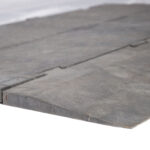 Capture a detailed snapshot of a gray, rectangular Omni Deck Trim stone slab from T3 Event Rentals, proudly serving the Forsyth County area. This rental piece showcases its visible edges and slight texture, with a smooth surface and subtle color variations. The distinct 42 marking is prominently featured on one side. Perfect for enhancing your next Forsyth County event with T3s top-quality rentals!.
