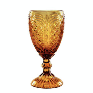 The Amber Vintage Glass, a beautifully ornate amber-colored goblet featuring a textured bowl design and decorative stem, is available through T3 Event Rentals. Perfect for enhancing any event, it stands out elegantly against a plain white background. Rent this exquisite piece for your next occasion in Dahlonega.