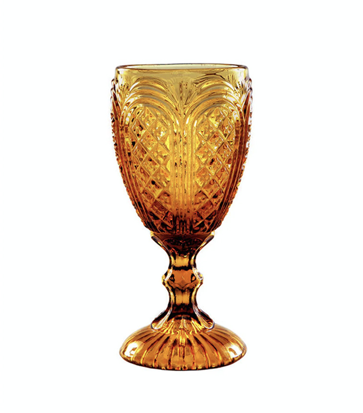 The Amber Vintage Glass, a beautifully ornate amber-colored goblet featuring a textured bowl design and decorative stem, is available through T3 Event Rentals. Perfect for enhancing any event, it stands out elegantly against a plain white background. Rent this exquisite piece for your next occasion in Dahlonega.