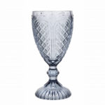 The Blue Vintage Glass offered by T3 Event Rentals showcases a stunning decorative vintage blue design, characterized by its intricate, textured pattern and elegant flared stem. Perfect for events in Dahlonega, this rental piece beautifully contrasts against a plain white background, adding a unique touch to any occasion.