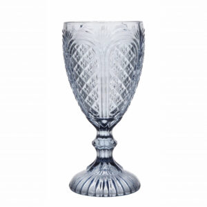 The Blue Vintage Glass offered by T3 Event Rentals showcases a stunning decorative vintage blue design, characterized by its intricate, textured pattern and elegant flared stem. Perfect for events in Dahlonega, this rental piece beautifully contrasts against a plain white background, adding a unique touch to any occasion.