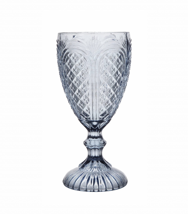 The Blue Vintage Glass offered by T3 Event Rentals showcases a stunning decorative vintage blue design, characterized by its intricate, textured pattern and elegant flared stem. Perfect for events in Dahlonega, this rental piece beautifully contrasts against a plain white background, adding a unique touch to any occasion.