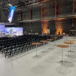 Event Photo of black resin chairs at a networking event.