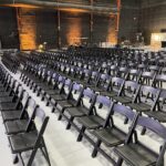 Event Photo of black resin chairs at a networking event.