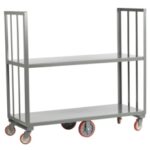 T3 Event Rentals offers a versatile gray metal utility cart with open-sided shelves, supported by vertical bars and featuring red-rimmed wheels. Ideal for events in Dawsonville, this cart comes with a Surge Protector Strip on the lower shelf and is set against a plain white background. Rent it from T3 Event Rentals today!.