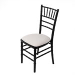 Discover the elegance of our Black Chiavari Chair, with its white cushioned seat and vertically slatted backrest. This stunning piece is photographed from an elevated angle against a pristine white backdrop. Explore this chic seating option and more at T3 Event Rentals. Perfect for events in Atlanta, we offer premium chair rentals to elevate your occasions style.