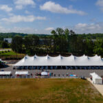 Aerial event photo of our 60' rope and pole tent along with several other tents.