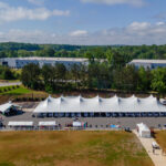 Aerial event photo of our 60' rope and pole tent along with several other tents.