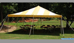 Experience the ultimate outdoor event ambiance with T3 Event Rentals beneath a charming yellow and white striped rope and pole tent set up in the heart of Dawsonville. Nestled on lush green grass, this spacious 20X20 rental tent accommodates several round tables and chairs, perfect for any gathering. Beautiful trees frame the background, offering a serene view of nature against a patch of bare soil. Choose T3 Event Rentals for your next occasion in Dawsonville and ensure an unforgettable setting.