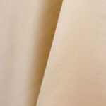 Discover the beauty of The Satin Sand Linens, available for your next North Georgia event through T3 Event Rentals. These linens feature a textured beige surface with a refined diagonal shadow. Perfect lighting brings out their smooth, satin-like sheen and slightly grainy texture, capturing the essence of fine linens. Rent these exquisite pieces to elevate your event experience.