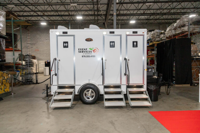 An air conditioned bathroom trailer inside T3 Event Rentals' Warehouse