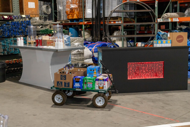 A cart full of beer beside our Delano Table and Bubble Bar