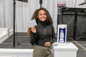 Prize winner holding up her winnings