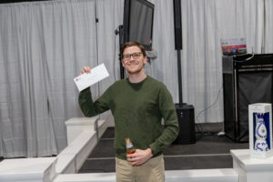 Prize winner holding up his winnings