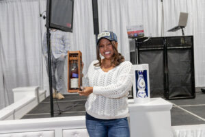 Prize Winner holding up her bottle of Bookers