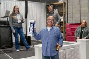 Prize winner holding up his bottle of Clase Azul