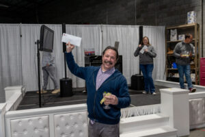 Prize winner holding up his winnings