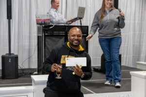 Prize winner holding up his winnings