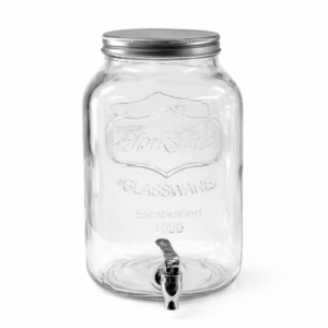 A clear glass beverage dispenser with a metal screw-on lid and spigot at the bottom, available for rent from T3 Event Rentals in Dahlonega. Perfect for events, this dispenser is displayed on a white surface against a plain gray background. All items are rentals—nothing for sale!.