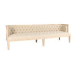 A long, light-colored upholstered bench with a tufted backrest and sturdy wooden frame, supported by six legs—available for rent from T3 Event Rentals in North Georgia. This elegant bench adds sophisticated comfort to weddings and special events throughout the North Georgia area. Contact T3 Event Rentals for top-quality event furniture rentals near you.