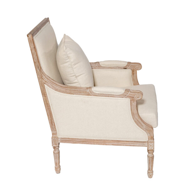 Side view of the Roswell Chair Ivory, available for rental from T3 Event Rentals in Forsyth County. This stylish armchair features a light wood frame with elegant carved details and plush ivory upholstery on the seat, back, and cushion. A cozy pillow completes the look, reflecting the signature Roswell Furniture style—perfect for upscale events or weddings in Forsyth County. Remember, all items are rentals from T3 Event Rentals; nothing is for sale.