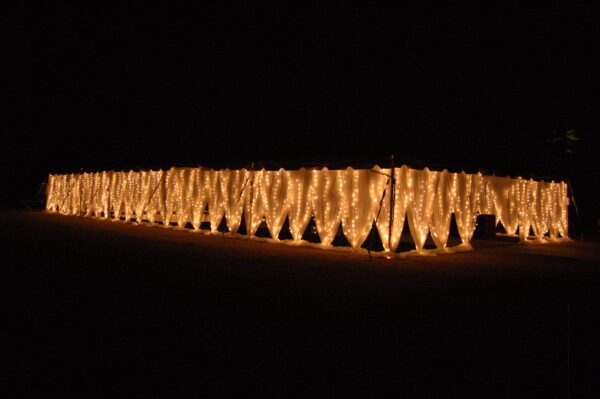 T3 Event Rentals’ twinkle lights glow on a draped structure in Dahlonega, creating magical nights with our rental decor.