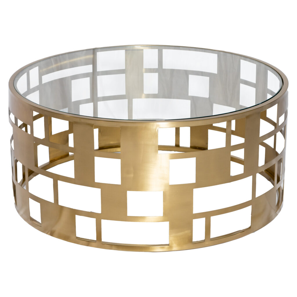 Make a statement at your next event with the Buckhead Coffee Table rental from T3 Event Rentals. This modern glam piece features an open geometric drum base in brushed gold paired with a clear tempered glass top. It’s the perfect combination of elegance and functionality, designed to complement a variety of event décor styles. Why Choose the Buckhead Coffee Table Rental: Brushed-gold drum base with a bold geometric cut-out pattern Clear tempered glass top for safety and style Versatile design works for modern, glam, and contemporary event themes Large surface space for décor, drinks, and event styling Complements our sofas, lounge chairs, and accent seating collections Perfect For: Wedding lounge seating areas VIP hospitality spaces at corporate events Charity galas and award ceremonies Brand activations and photo-worthy lounges Specifications Dimensions: Approx. 36″ diameter × 17″ height Top Material: Tempered clear glass Base Material: Metal with brushed-gold finish Style: Modern Glam Geometric Drum Indoor Use: Yes Outdoor Use: Covered areas only Category: Lounge Furniture / Coffee Tables Product Identifiers Name: Buckhead Coffee Table Rental Color: Brushed Gold & Clear Material: Metal & Tempered Glass Dimensions: 36″ × 17″ (approx.) Style: Modern Glam Geometric Drum Category: Lounge Furniture / Coffee Tables Use Cases Anchor a wedding lounge area with modern elegance Pair with plush seating for a cohesive VIP lounge setup Style with floral arrangements or candles for eye-catching décor Use as a centerpiece for corporate hospitality lounges