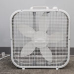A five-blade box fan from T3 Event Rentals sits on carpet in Dawsonville, ready for your next event rental. Brand visible.