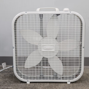 A five-blade box fan from T3 Event Rentals sits on carpet in Dawsonville, ready for your next event rental. Brand visible.