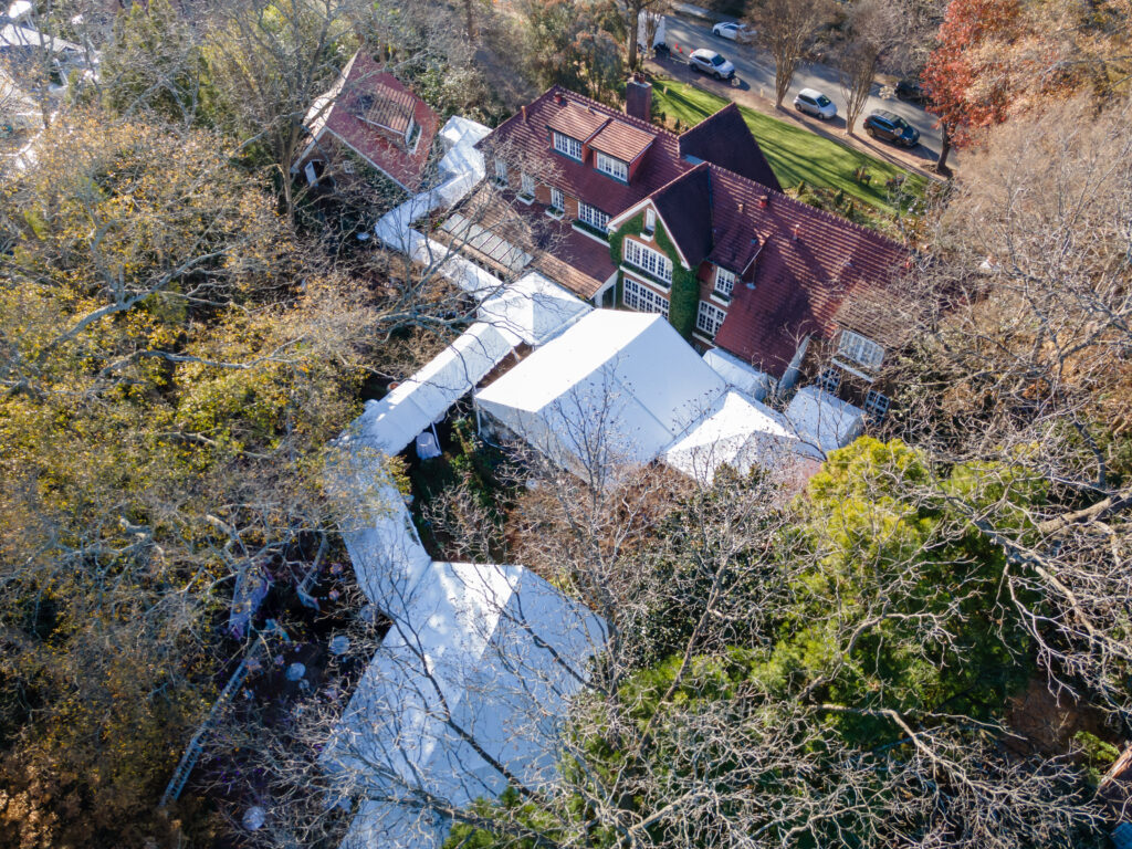 Custom tent installations showing connected marquee tents in a residential backyard