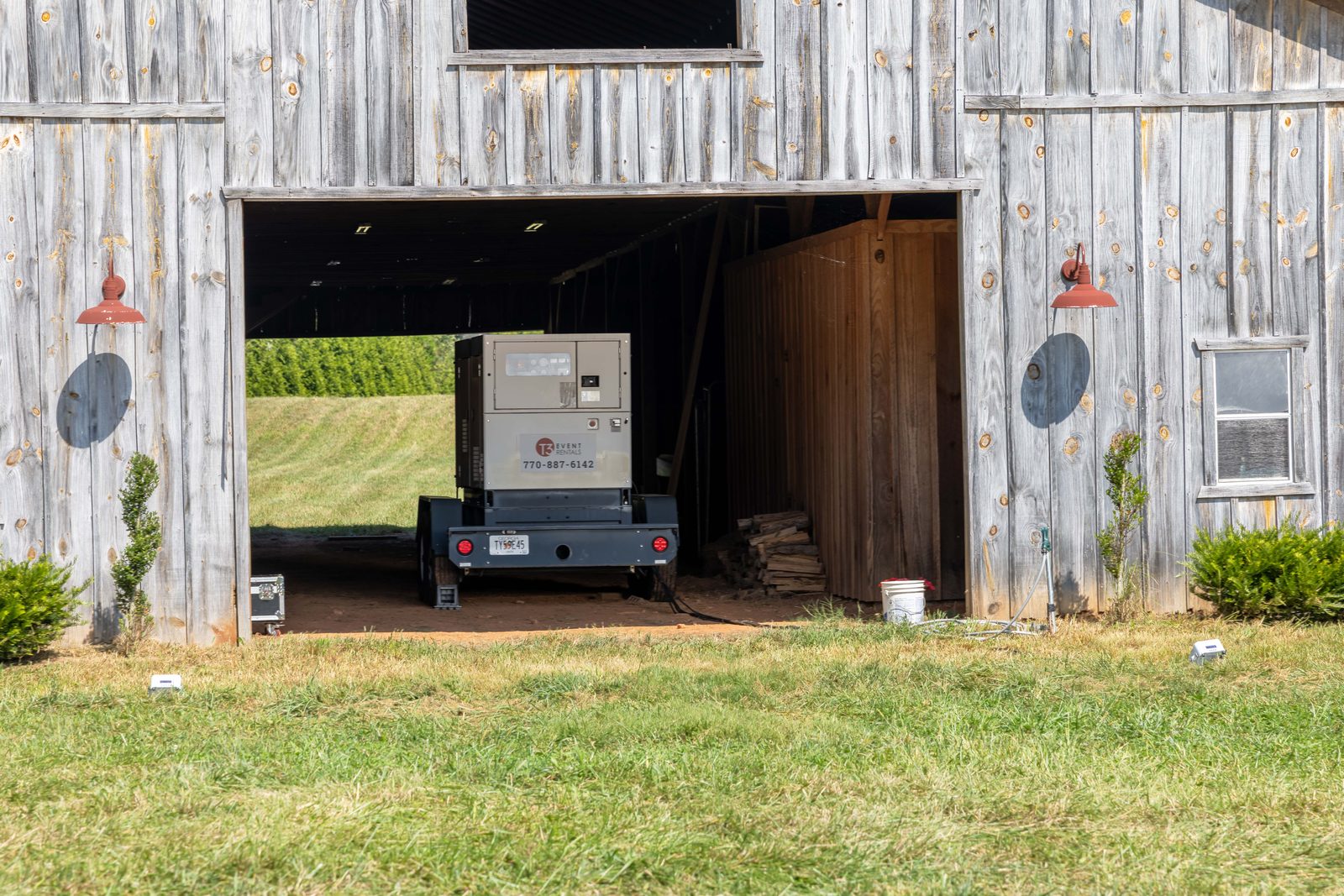 100KW generator parked inside a barn doorway on the wedding property.