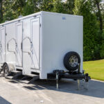 Four stall restroom trailer showing the hitch end and spare wheel