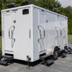 Four stall restroom trailer exterior showing individual stall doors