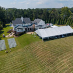 Aerial view showing the full hundred foot length of a white top frame tent